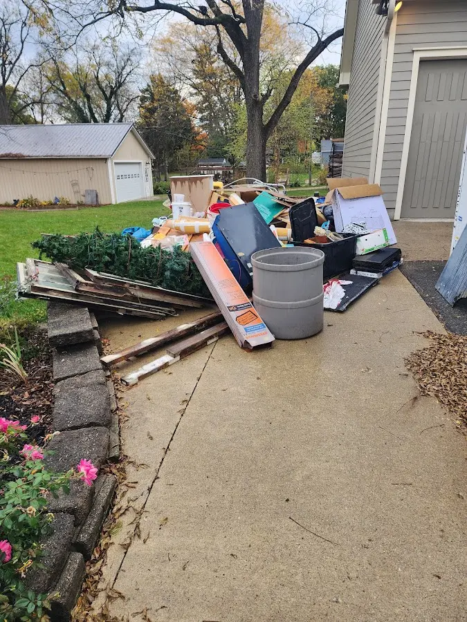 Dumpster being loaded with debris for Estate Cleanout Dumpster Rental in Mandan